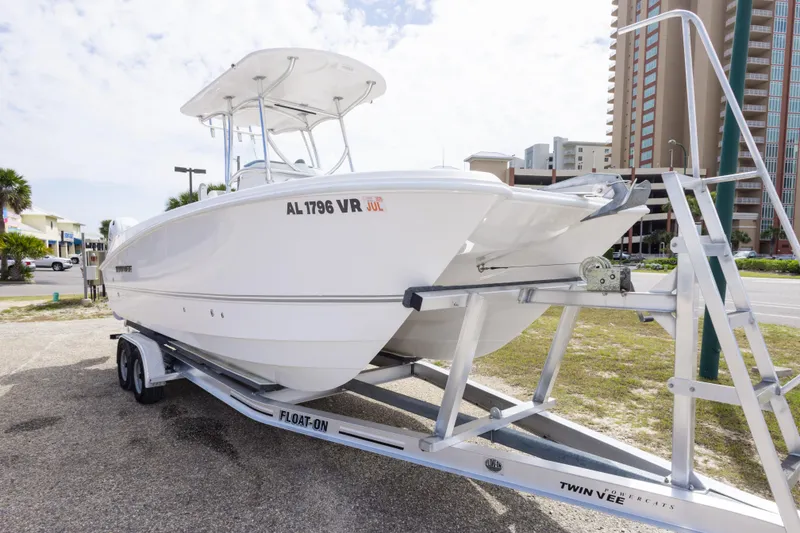Slide: The Image of 2022 Twin Vee 240 GFX CC boat on trailer, parked near buildings. - 3