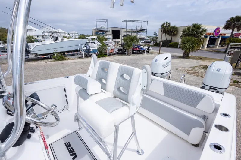 Slide: The Image of 2022 Twin Vee 240 GFX CC boat interior with seating and Suzuki engines. - 32