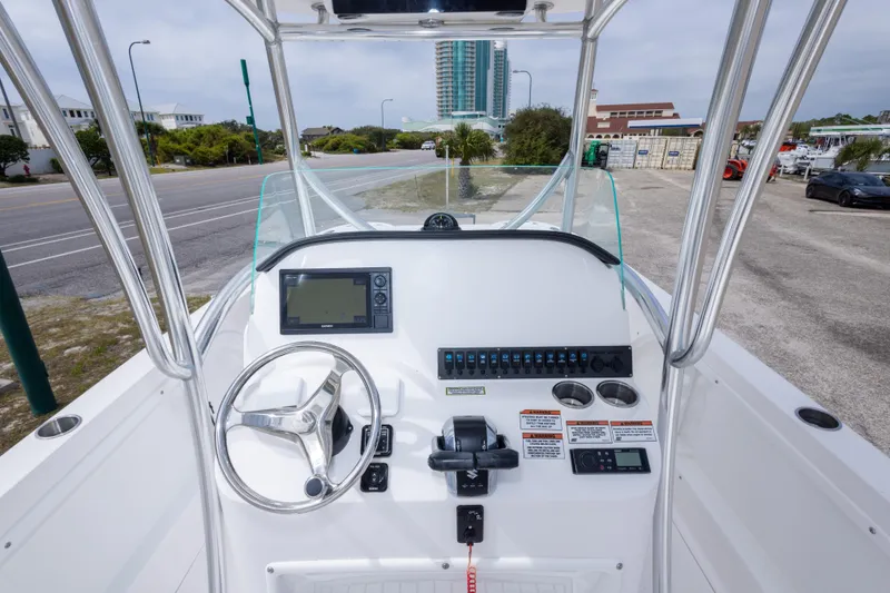 Slide: The Image of 2022 Twin Vee 240 GFX CC boat console with steering wheel and navigation controls. - 33