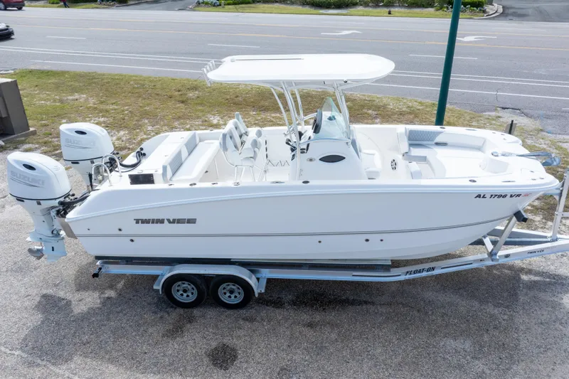 Slide: The Image of 2022 Twin Vee 240 GFX CC boat on trailer, featuring dual Suzuki engines. - 37