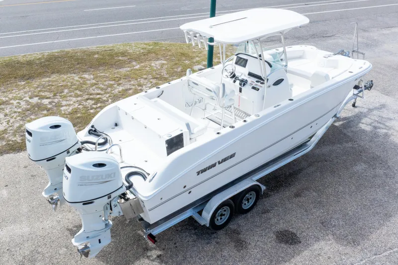 Slide: The Image of 2022 Twin Vee 240 GFX CC boat with dual Suzuki engines on a trailer. - 38