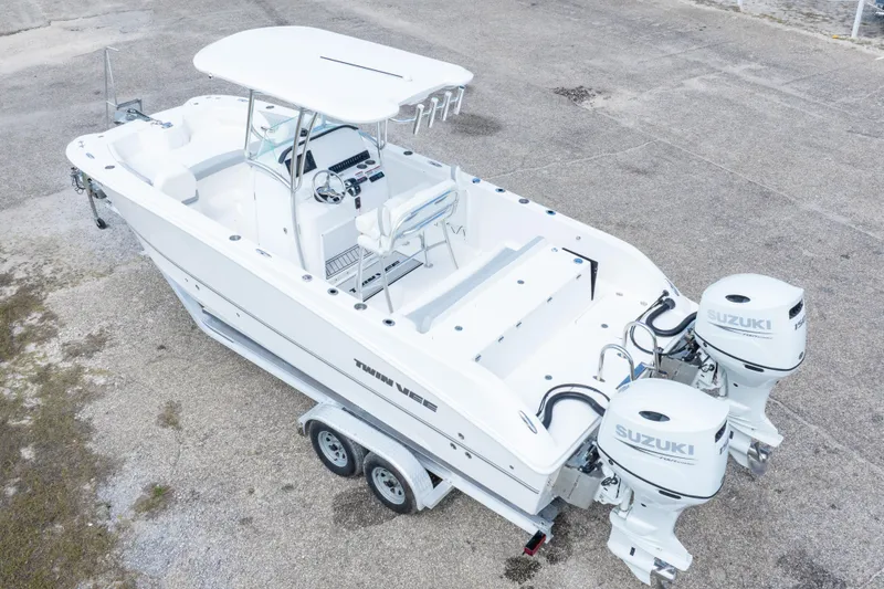 Slide: The Image of 2022 Twin Vee 240 GFX CC boat with dual Suzuki outboard motors on trailer. - 40