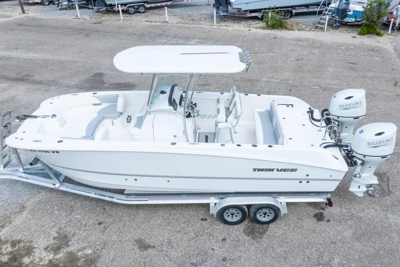 Slide: The Image of 2022 Twin Vee 240 GFX CC boat with dual Suzuki engines on a trailer. - 41