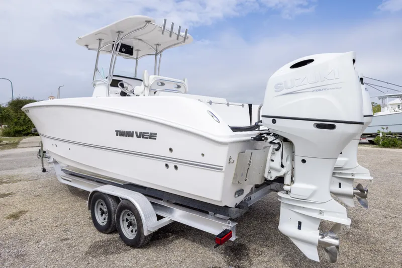 Slide: The Image of 2022 Twin Vee 240 GFX CC boat with Suzuki outboard engines on a trailer. - 7