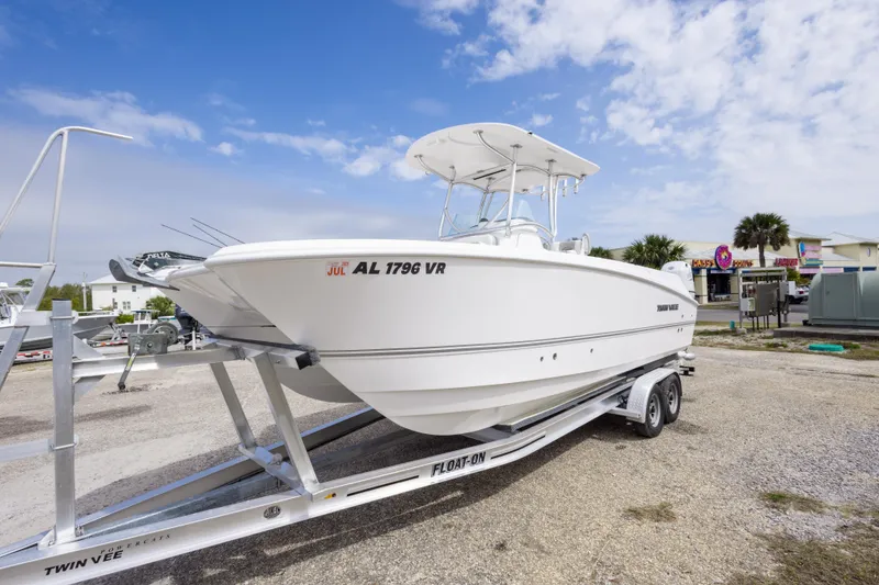 Slide: The Image of 2022 Twin Vee 240 GFX CC boat on trailer, parked outdoors under a blue sky. - 9
