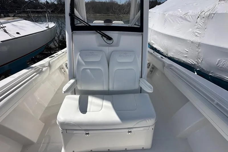 Slide: The Image of 2021 Regulator 28 Forward Seating boat interior with white cushioned seats. - 14