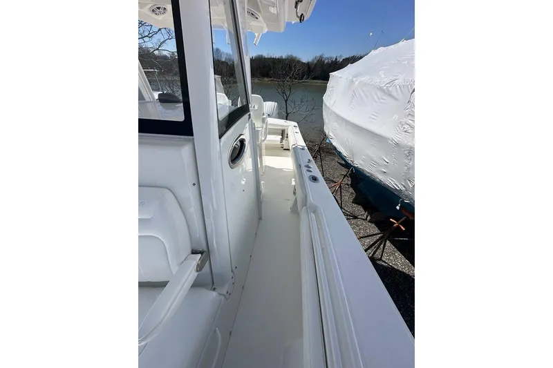 Slide: The Image of 2021 Regulator 28 Forward Seating boat, side view, docked near water. - 17