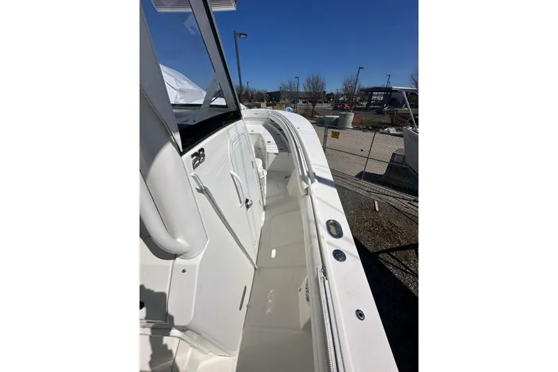 Slide: The Image of 2021 Regulator 28 Forward Seating boat, white deck, outdoor display. - 18