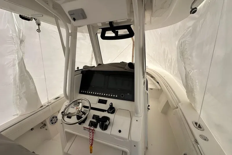 Slide: The Image of 2021 Regulator 28 Forward Seating boat interior with modern helm and controls. - 5