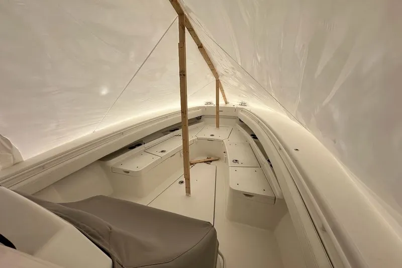 Slide: The Image of 2021 Regulator 28 Forward Seating boat interior under protective cover. - 6