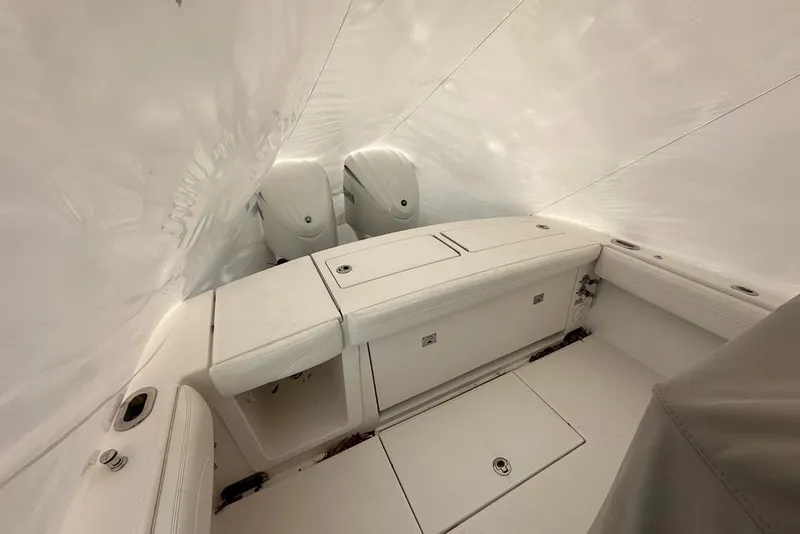 Slide: The Image of 2021 Regulator 28 Forward Seating boat interior with dual engines, covered in protective wrap. - 7