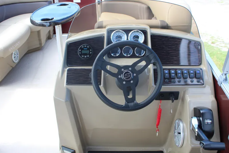 Slide: The Image of 2026 Sylvan Mirage Fish 820 Party Fish boat dashboard with steering wheel and controls. - 1