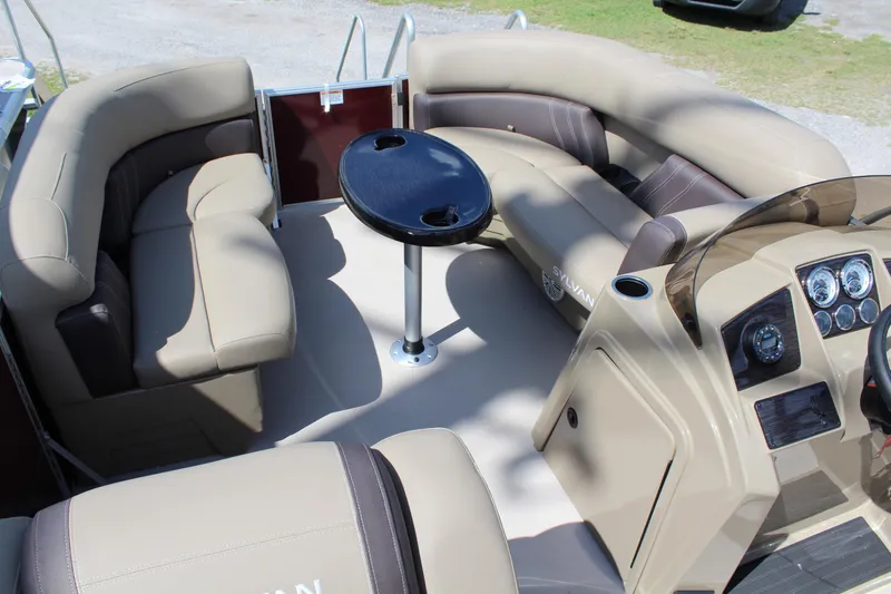 Slide: The Image of 2026 Sylvan Mirage Fish 820 Party Fish boat interior with beige seating and central table. - 10