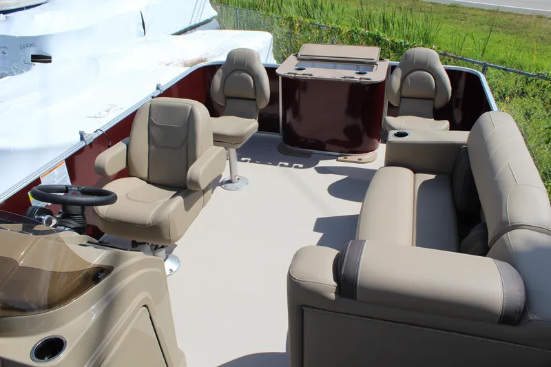 Slide: The Image of 2026 Sylvan Mirage Fish 820 Party Fish boat interior with beige seating and steering console. - 11