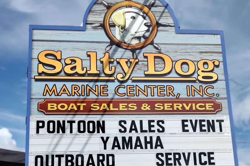 Slide: The Image of Salty Dog Marine Center sign advertising pontoon sales event and services, featuring Yamaha. - 13