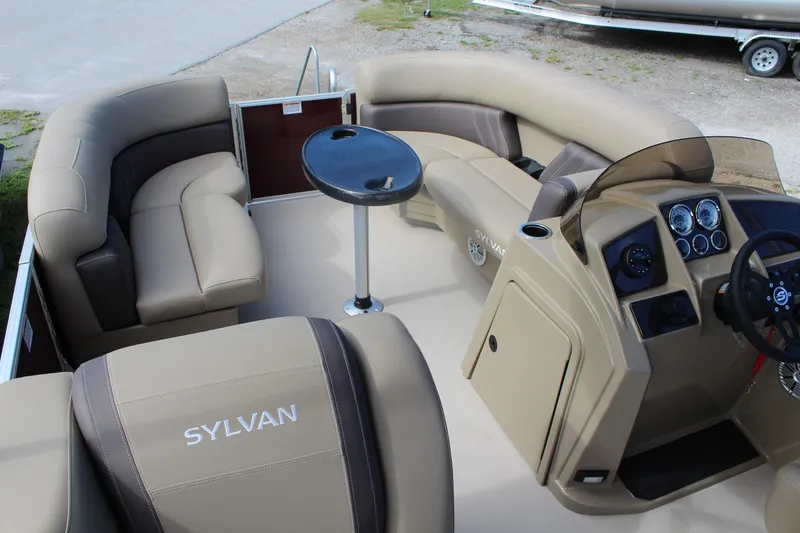 Slide: The Image of 2026 Sylvan Mirage Fish 820 Party Fish boat interior with plush seating and control panel. - 5