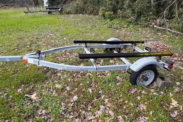 Slide: The Image of Trailer for 1988 Boston Whaler 130 Super Sport on grassy area. - 4