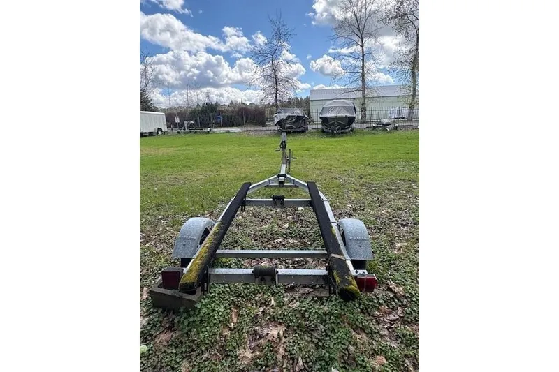 Slide: The Image of Empty boat trailer on grass, suitable for 1988 Boston Whaler 130 Super Sport. - 6