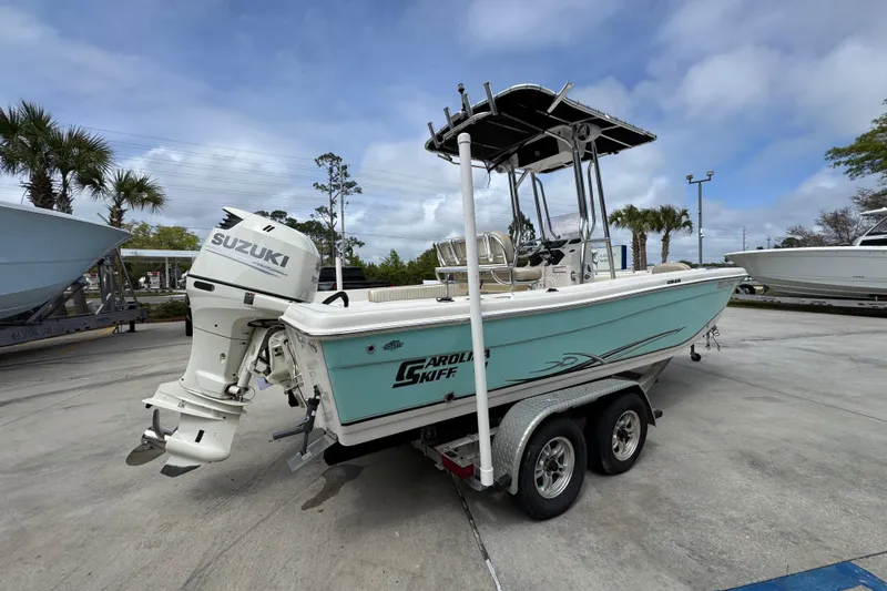 Slide: The Image of 2019 Carolina Skiff 21 Ultra Elite boat with Suzuki outboard motor on trailer. - 10