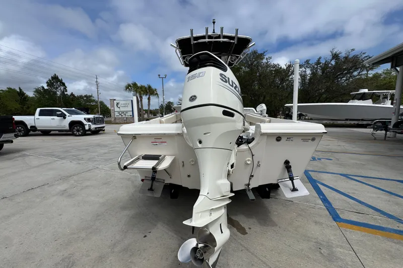 Slide: The Image of 2019 Carolina Skiff 21 Ultra Elite boat with Suzuki outboard motor in parking lot. - 12
