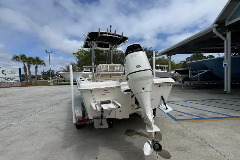 Slide: The Image of 2019 Carolina Skiff 21 Ultra Elite boat with outboard motor in marina parking lot. - 13