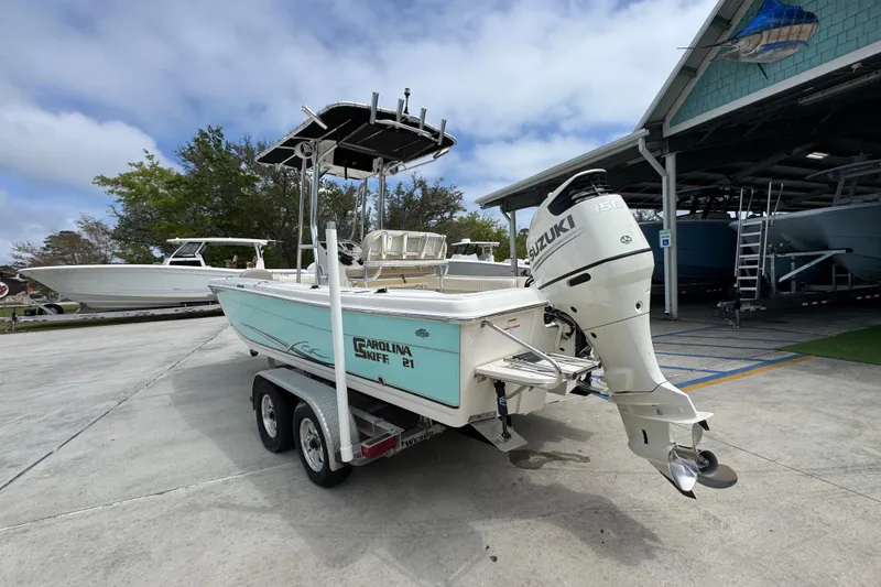 Slide: The Image of 2019 Carolina Skiff 21 Ultra Elite boat on trailer with Suzuki outboard motor. - 14