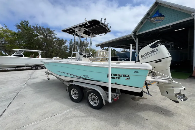 Slide: The Image of 2019 Carolina Skiff 21 Ultra Elite boat on trailer with Suzuki outboard motor. - 15