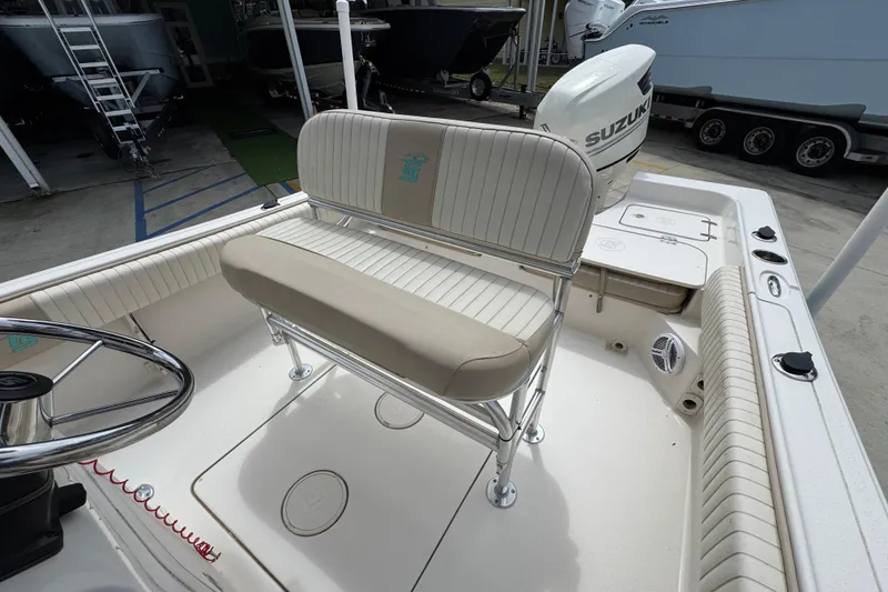 Slide: The Image of 2019 Carolina Skiff 21 Ultra Elite boat interior with seating and Suzuki outboard motor. - 25