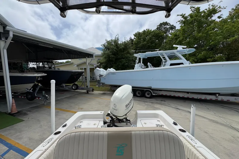 Slide: The Image of 2019 Carolina Skiff 21 Ultra Elite boat with Suzuki outboard motor in marina. - 27