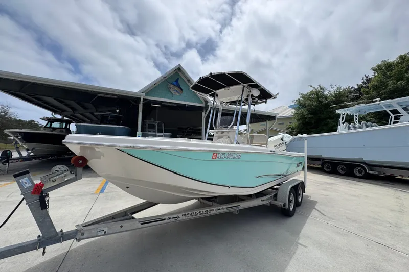 Slide: The Image of 2019 Carolina Skiff 21 Ultra Elite boat on trailer, parked outdoors. - 3