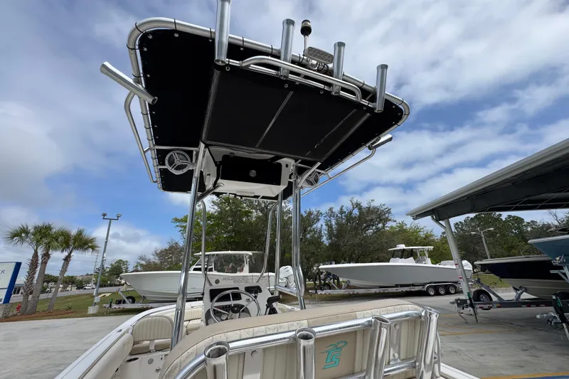 Slide: The Image of 2019 Carolina Skiff 21 Ultra Elite boat with T-top and rod holders, parked outdoors. - 34