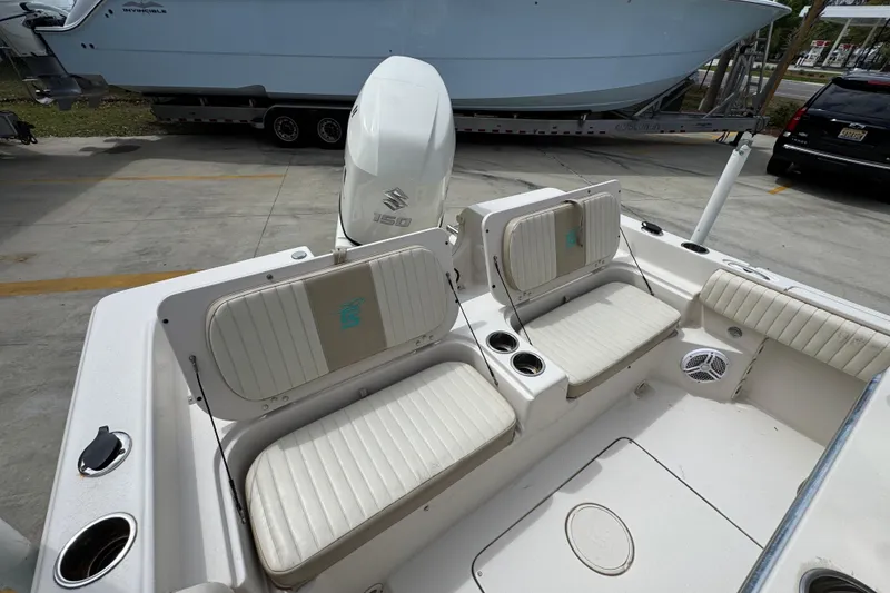 Slide: The Image of 2019 Carolina Skiff 21 Ultra Elite boat interior with seating and Suzuki 150 engine. - 37