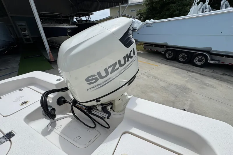 Slide: The Image of 2019 Carolina Skiff 21 Ultra Elite with Suzuki outboard motor in a boatyard. - 38