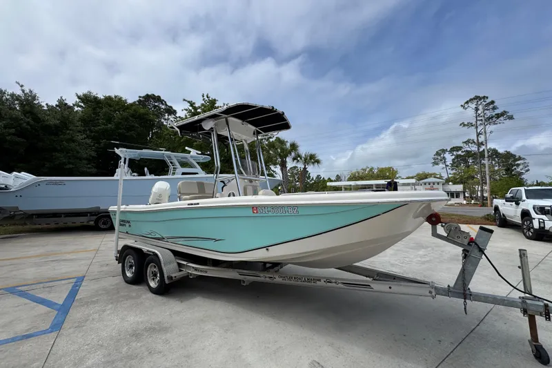 Slide: The Image of 2019 Carolina Skiff 21 Ultra Elite boat on trailer, parked outdoors. - 7
