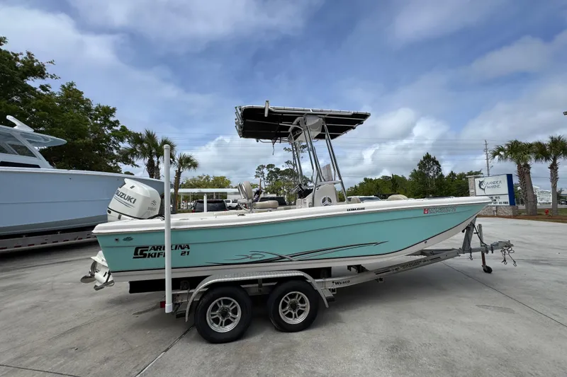 Slide: The Image of 2019 Carolina Skiff 21 Ultra Elite boat on trailer, parked outdoors. - 9