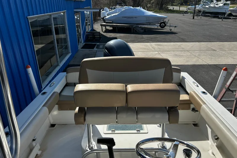 Slide: The Image of 2019 Parker 21 Special Edition boat interior with tan seating and steering wheel. - 10
