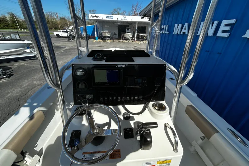 Slide: The Image of 2019 Parker 21 Special Edition boat dashboard with steering wheel and navigation controls. - 12