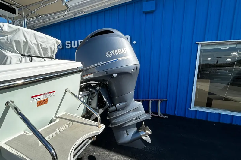 Slide: The Image of Parker 21 Special Edition boat with Yamaha outboard motor, 2019 model, near blue building. - 22