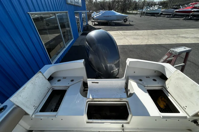 Slide: The Image of 2019 Parker 21 Special Edition boat with 150 HP engine at a dealership. - 7