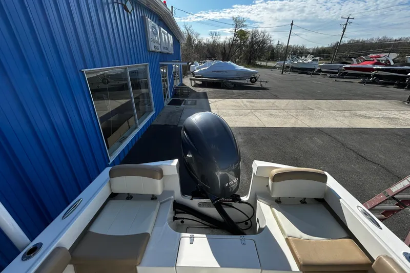 Slide: The Image of Parker 21 Special Edition boat, 2019 model, parked outside a blue building. - 8