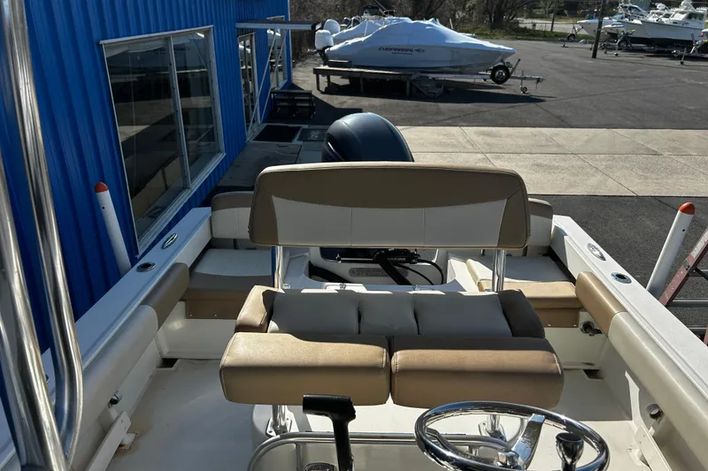 Slide: The Image of 2019 Parker 21 Special Edition boat interior with beige seating and steering wheel. - 9