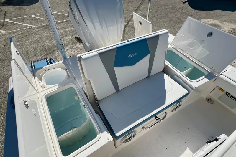 Slide: The Image of 2026 Robalo 246 Cayman boat interior with seating and storage compartments. - 10