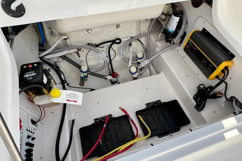Slide: The Image of 2026 Robalo 246 Cayman boat interior showing electrical and plumbing components. - 14