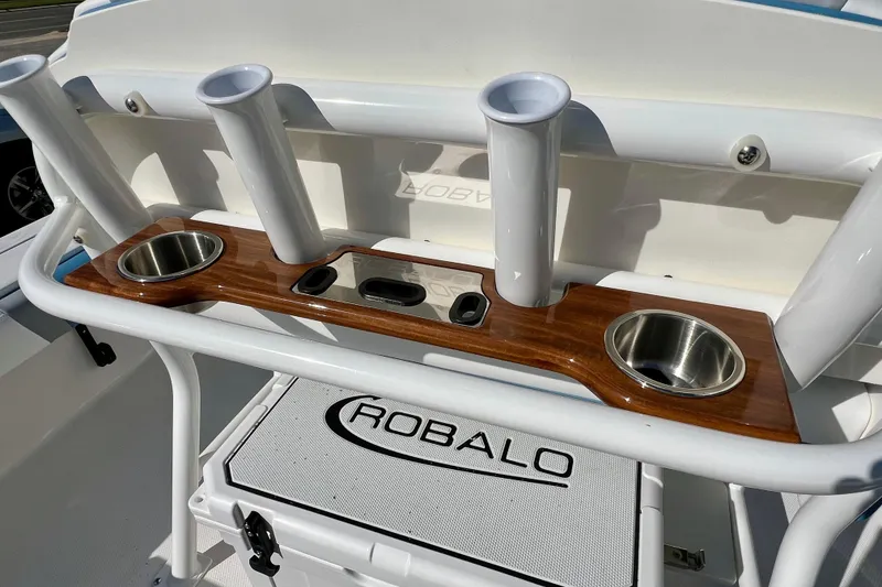 Slide: The Image of 2026 Robalo 246 Cayman boat console with rod holders and cup holders. - 15