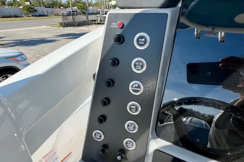 Slide: The Image of Control panel of 2026 Robalo 246 Cayman boat with various function buttons. - 20
