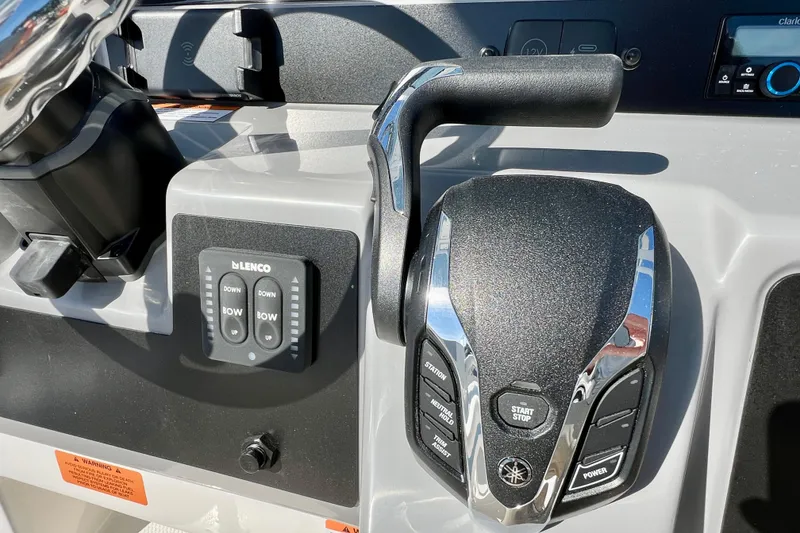 Slide: The Image of Control panel of 2026 Robalo 246 Cayman boat with throttle and trim controls. - 21