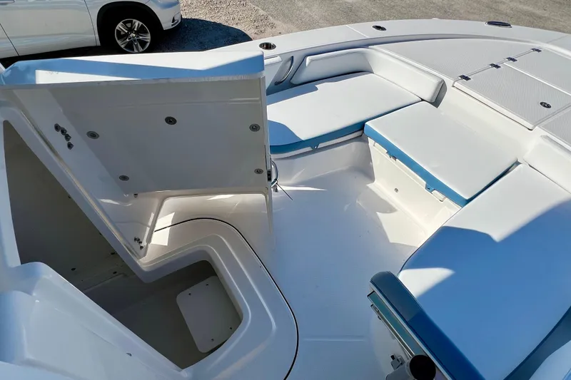 Slide: The Image of Interior view of 2026 Robalo 246 Cayman boat with seating and storage compartments. - 24