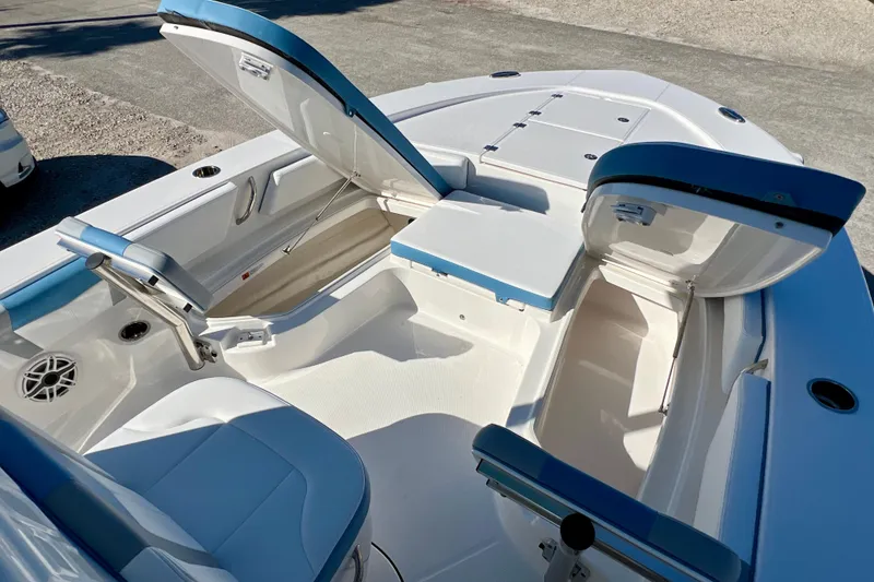 Slide: The Image of 2026 Robalo 246 Cayman boat interior with open storage compartments and seating. - 26