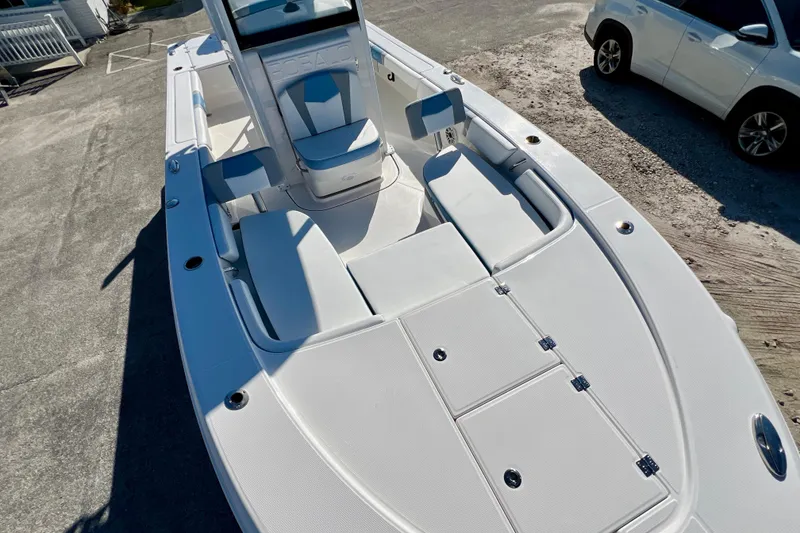 Slide: The Image of 2026 Robalo 246 Cayman boat with spacious deck and seating, parked on concrete. - 29