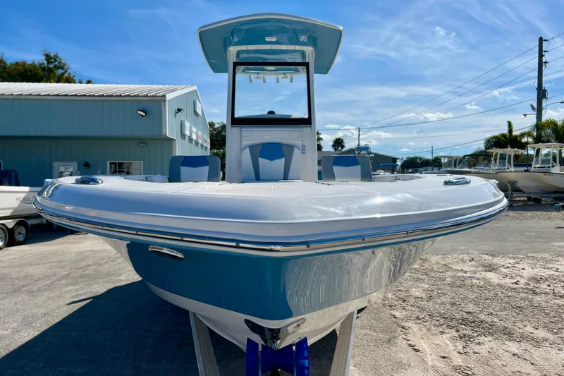 Slide: The Image of 2026 Robalo 246 Cayman boat displayed outdoors under a clear blue sky. - 3